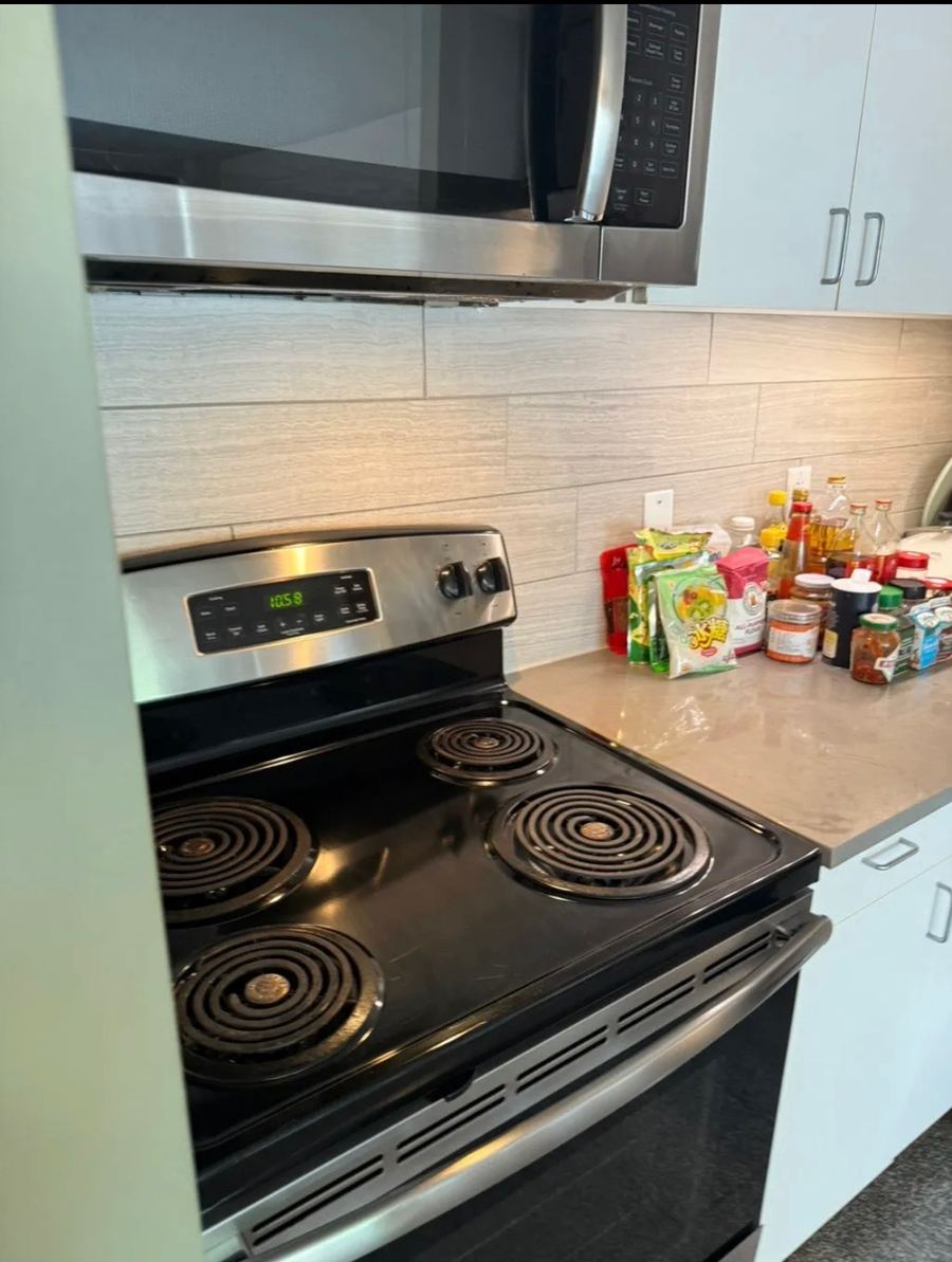 Organized kitchen with a gleaming stovetop after cleaning
