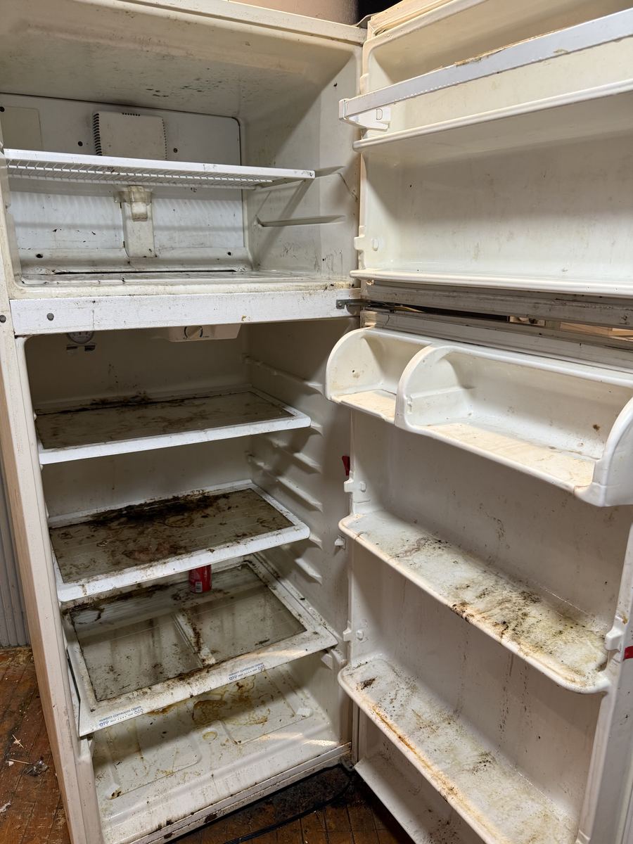 Refrigerator with spills and residue before cleaning